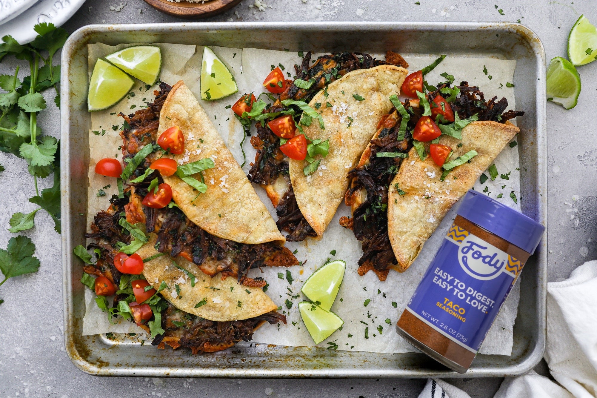 The ultimate low FODMAP tacos! An image of four of Fody's slow cooker braised beef tacos,