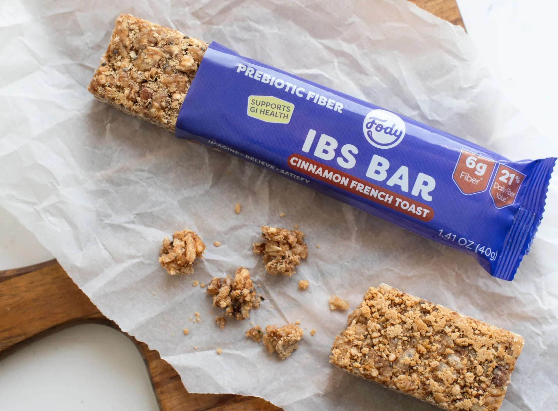 Fody Cinnamon French Toast Snack Bar with prebiotic fiber unwrapped on parchment paper