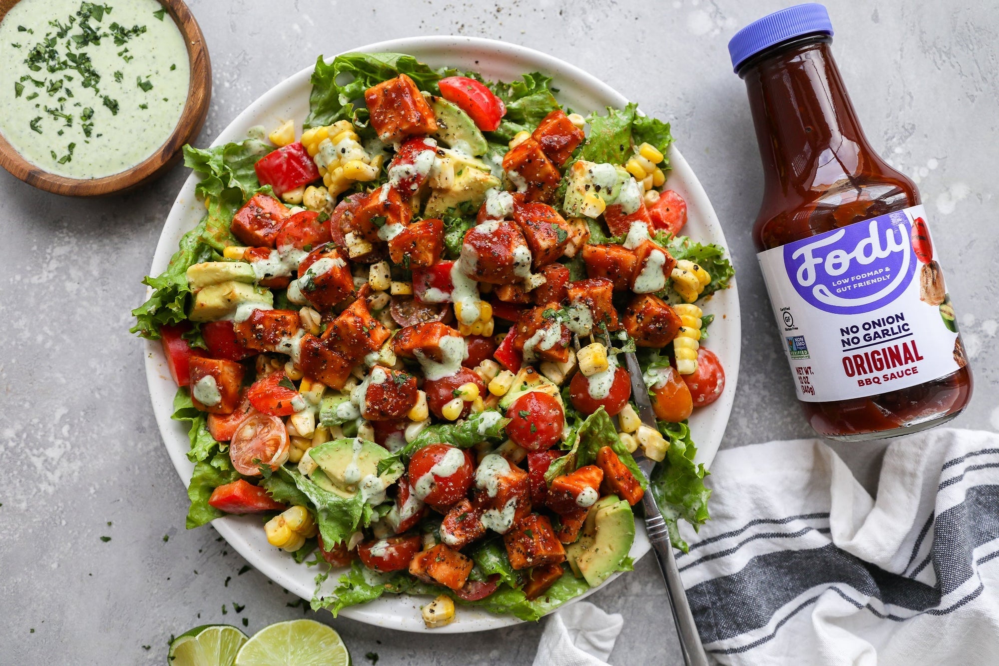 An image of a colourful plate of Fody's Low FODMAP BBQ Chicken Salad with Cilantro Lime Dressing.