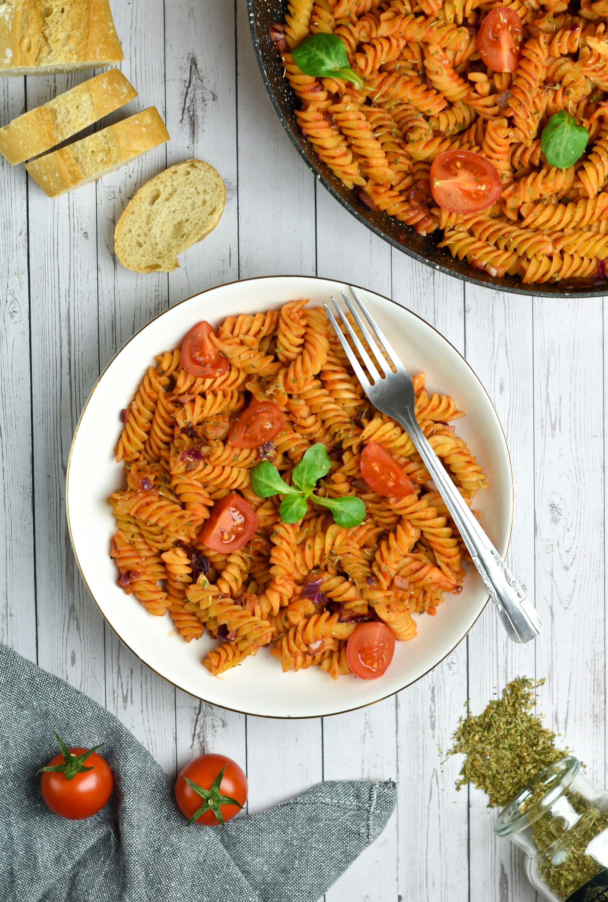 Pasta with tomato sauce on a white plate — a Low FODMAP dinner option for managing IBS and GERD together 