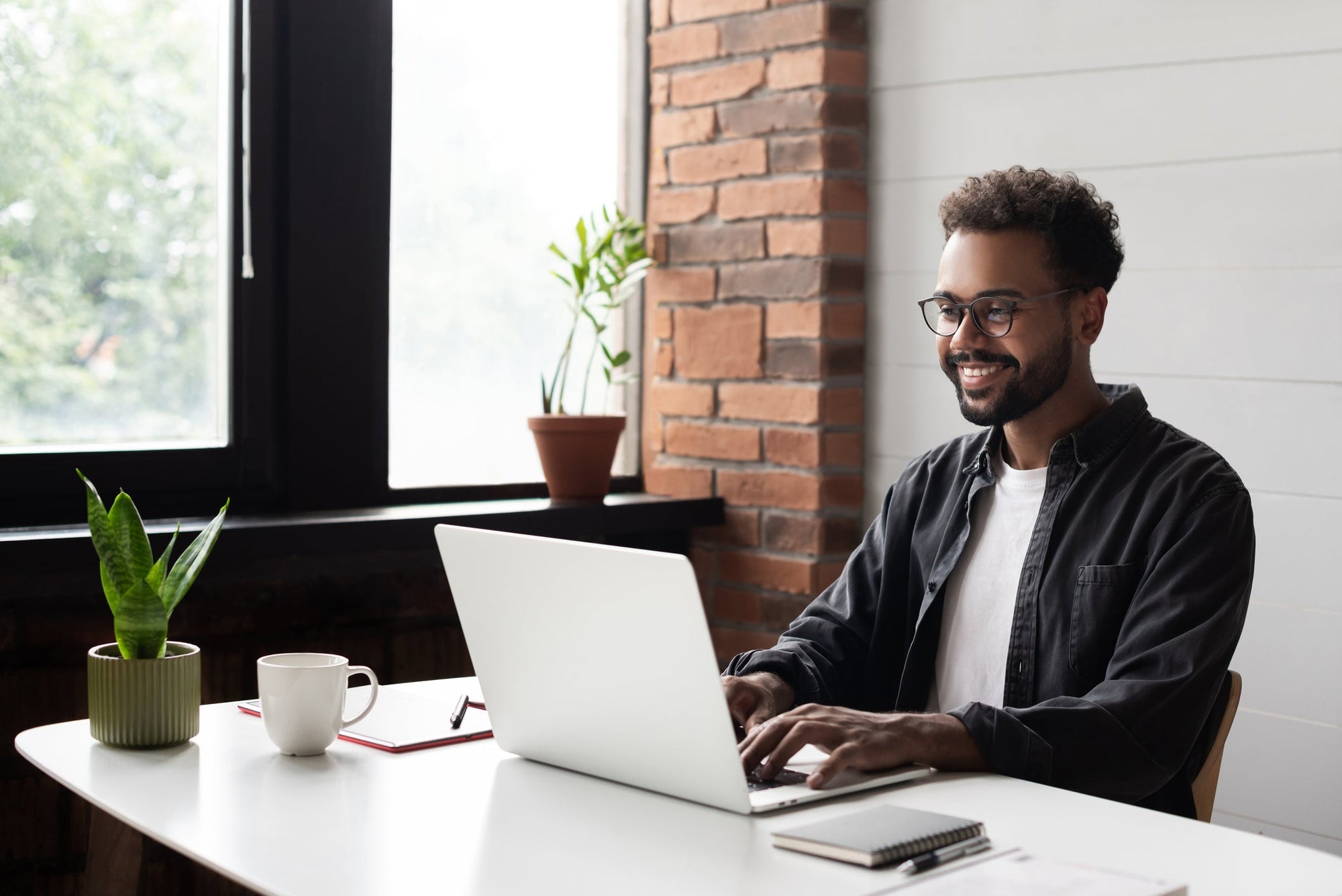 Stress and digestion are intimately connected; it’s important to understand the way they work together! Image: a young man looking calm and relaxed, sitting at a computer and working