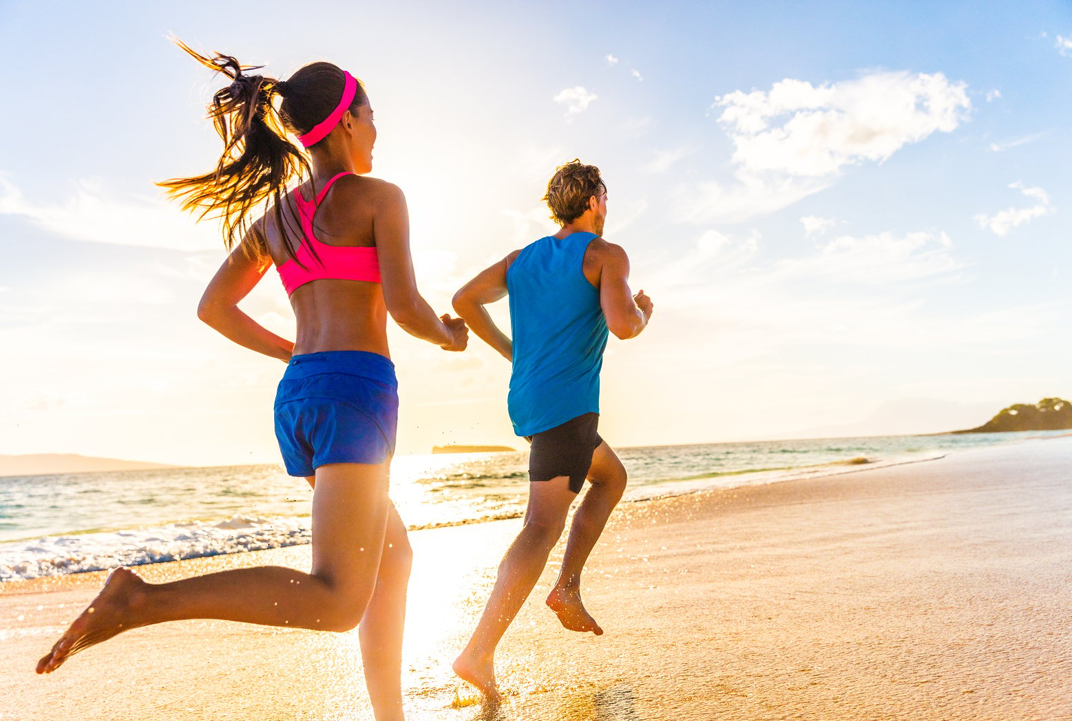 Man and woman running on a beach