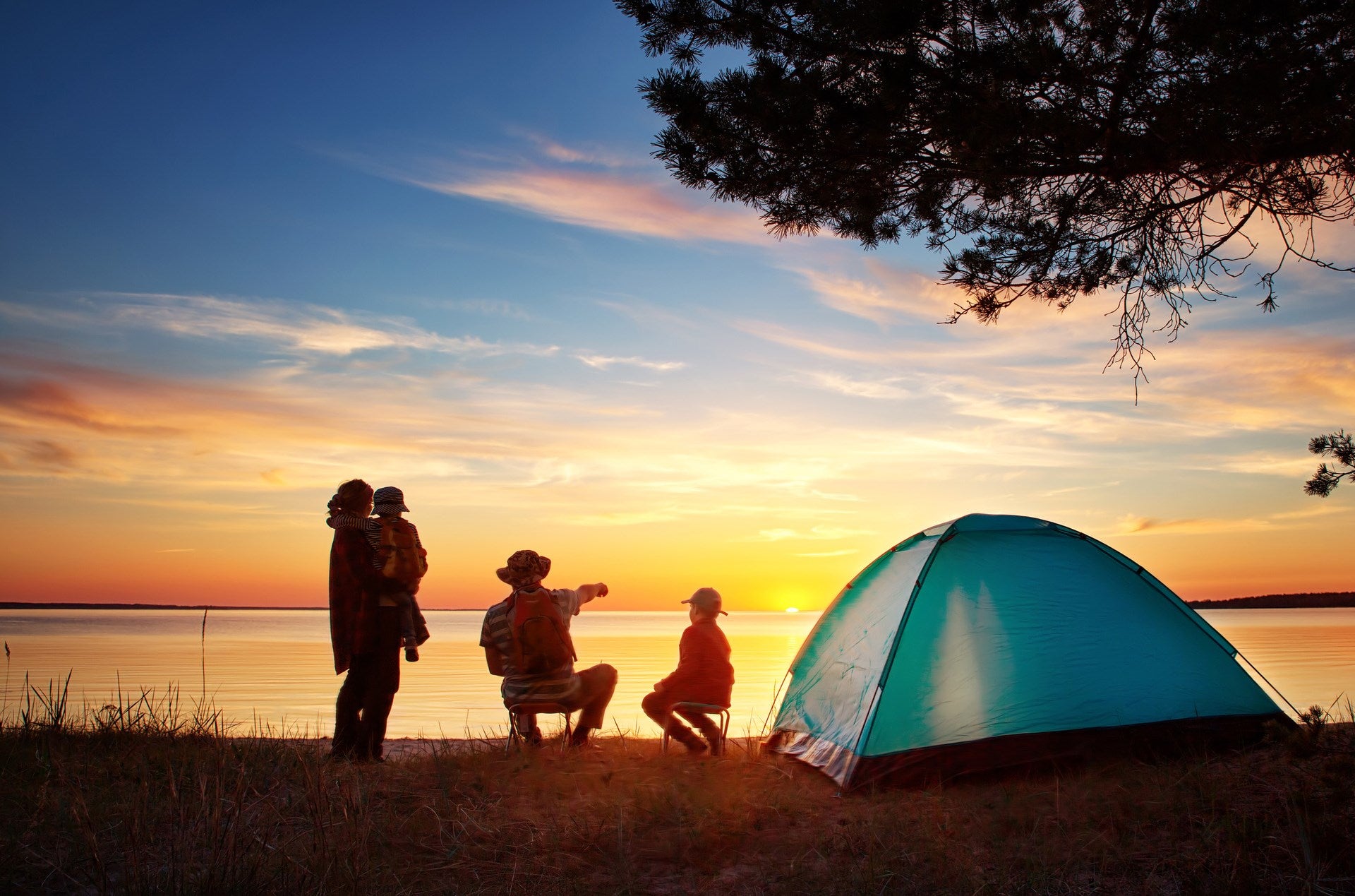 Family camping next to their tent