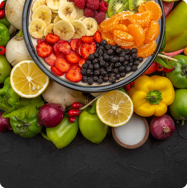 Avocado halves, a raw salmon fillet, mixed nuts, cherry tomatoes, berries and broccoli grouped together on a light surface, seen from above